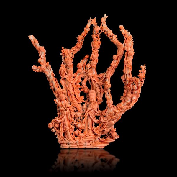Large group carved in coral depicting a dignitary with maidens and children, with floral motifs in relief, China, Qing Dynasty, 19th century