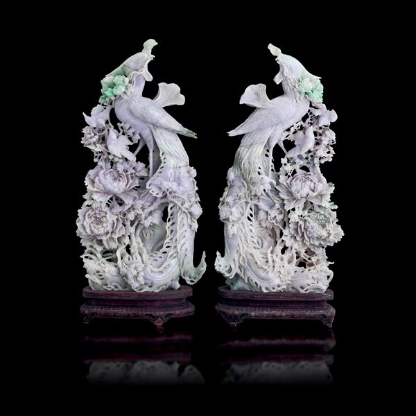 Pair of figures carved in jadeite in lavender tones with apple green hues depicting phoenixes with raised floral decorations, China, Qing Dynasty, early 20th century.
