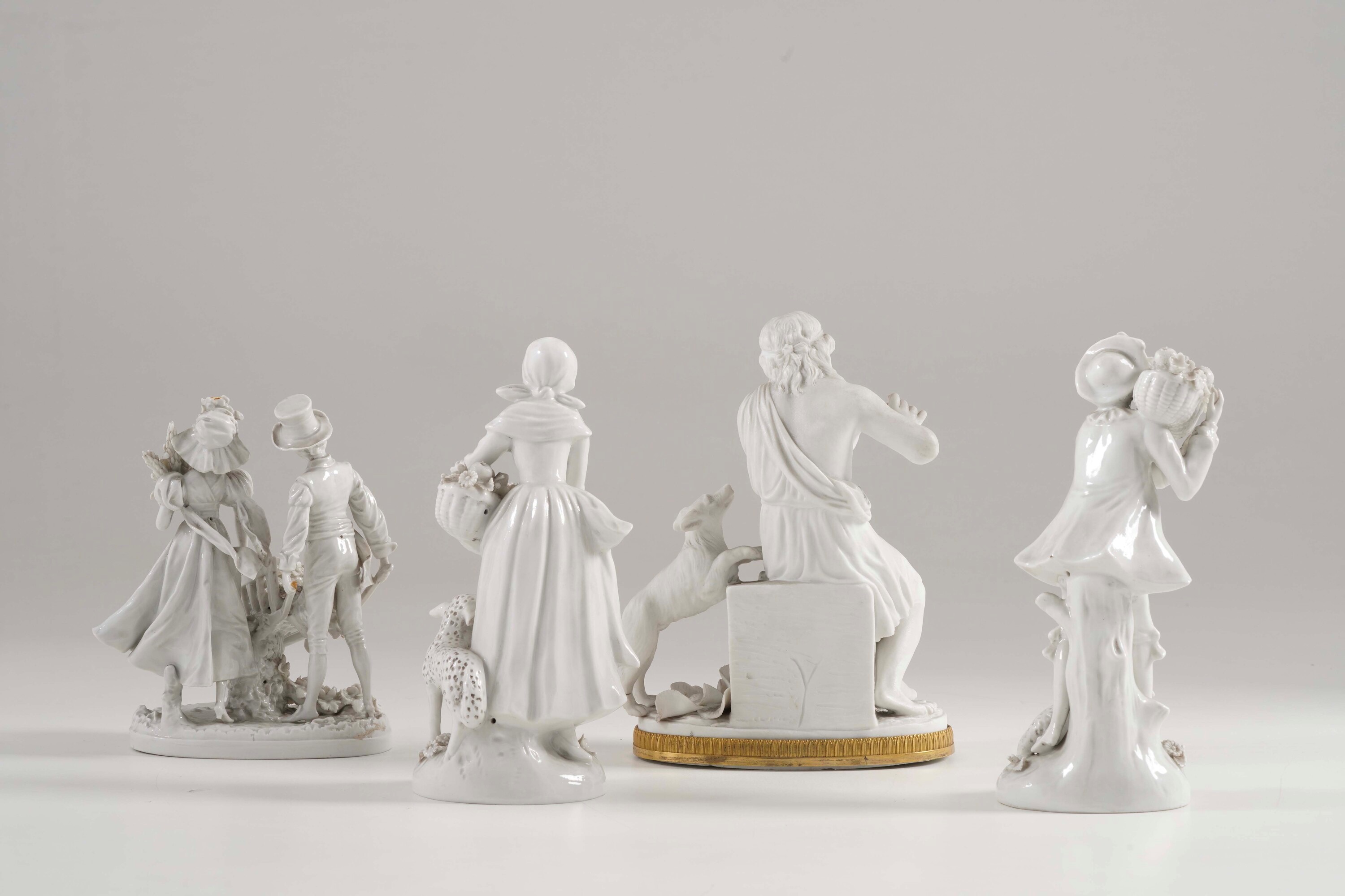 XX secolo, Due gruppi e una coppia di figurine in porcellana e biscuit, con marchio “N” coronata