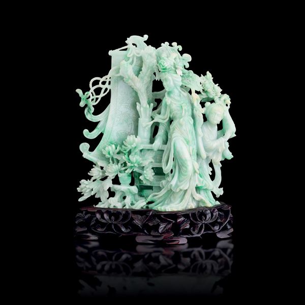 Jadeite figure depicting Guanyin with a girl, with raised vegetal decorations and incised floral motifs, China, Qing Dynasty, early 20th century