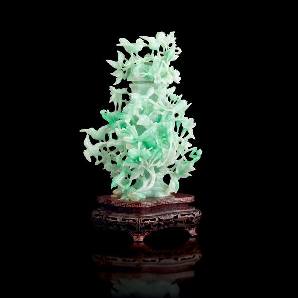 Lidded vase carved in apple green jadeite with raised decorations depicting flowers and birds, China, Qing Dynasty, early 20th century
