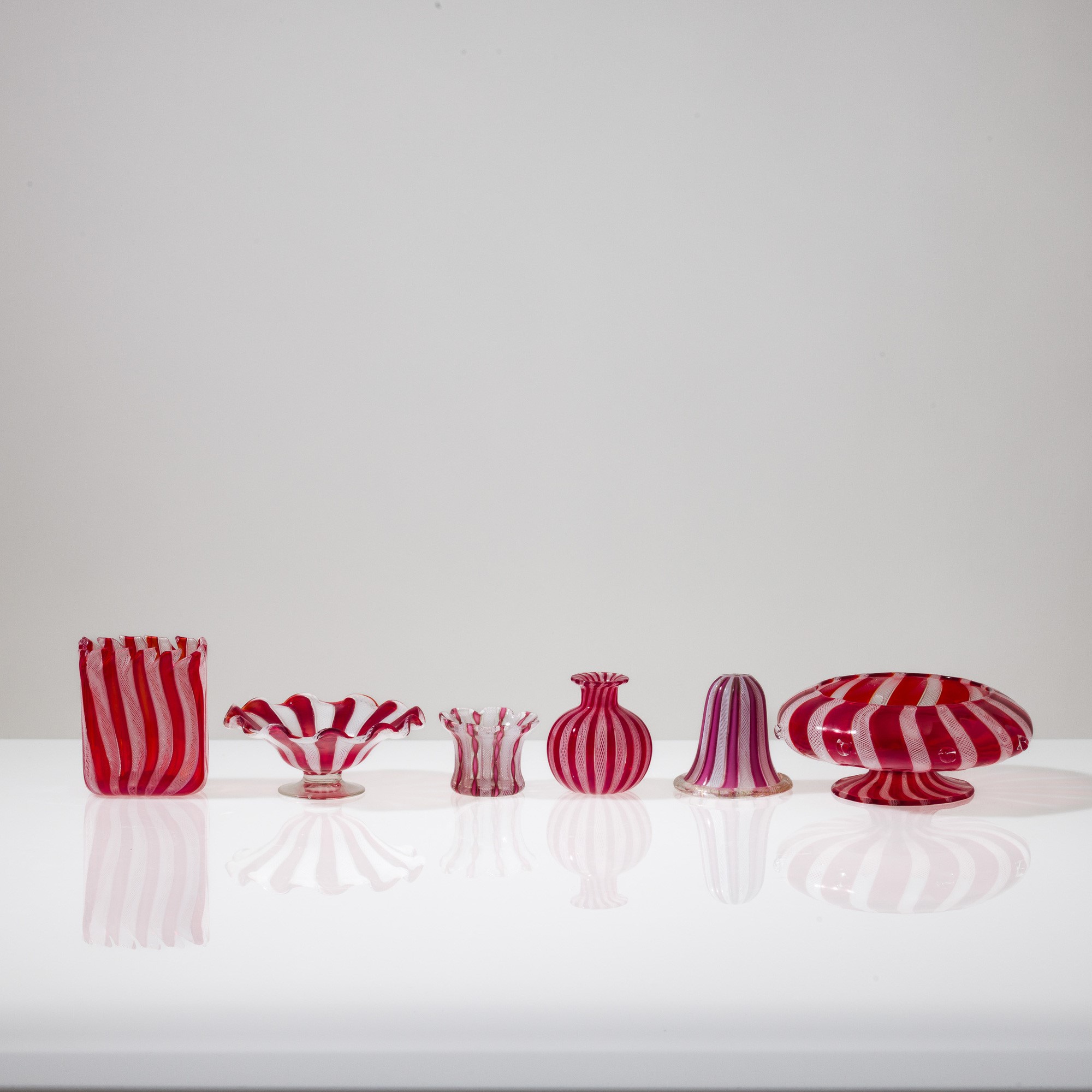 Murano, Collezione di dodici vasi in vetro soffiato con decorazione zanfirico e a reticello (XX s...