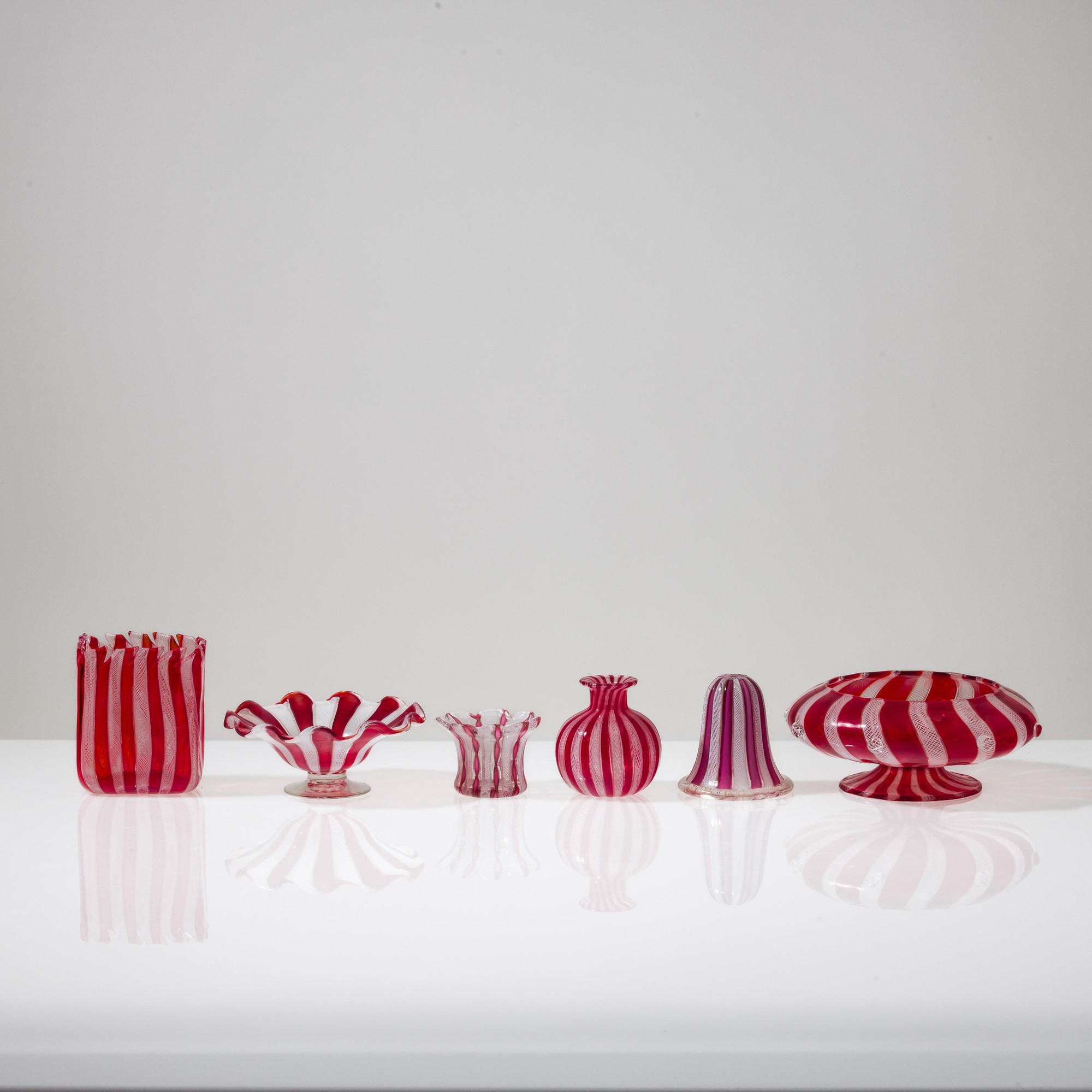 Murano, Collezione di dodici vasi in vetro soffiato con decorazione zanfirico e a reticello (XX s...