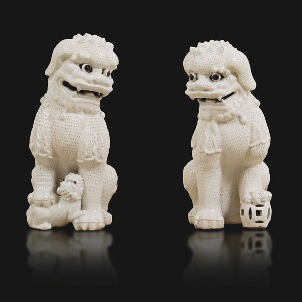 Pair of large blanc-de-Chine porcelain figures of Pho dogs, China, Qing Dynasty, 19th century.