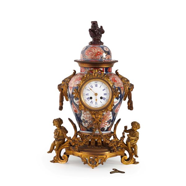 Pendola da camino in bronzo dorato e porcellana Imari. XIX secolo