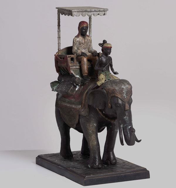 Scultura in metallo raffigurante “personaggi su elefante“