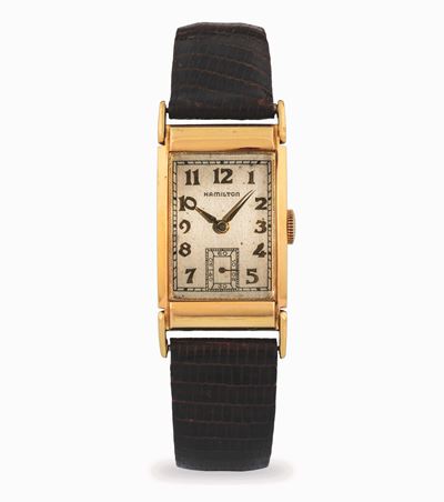 Orologio da uomo in oro giallo 14k con quadrante argentato e indici applicati, circa 1940