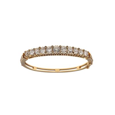 Bracciale rigido in oro giallo 750/1000 con undici diamanti di vecchio taglio per un totale di ci...