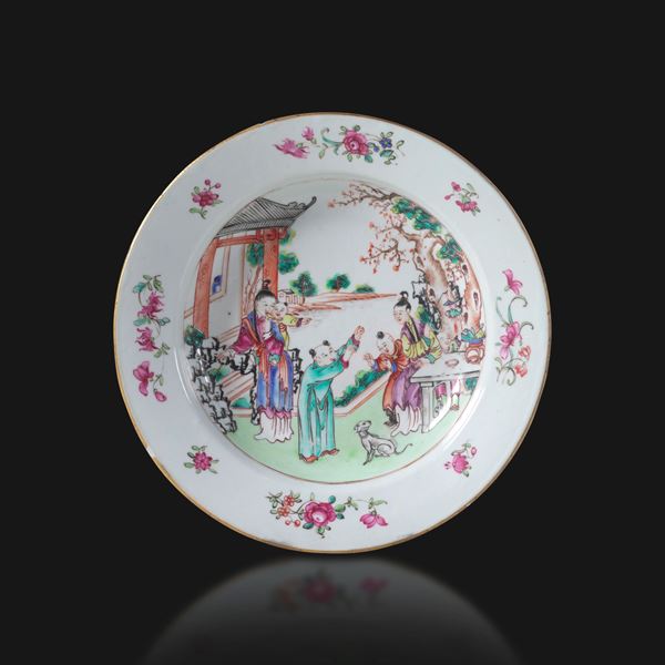 Famille rose porcelain plate depicting a genre scene with floral decoration, China, Qing Dynasty, Qianlong period (1736–1796).