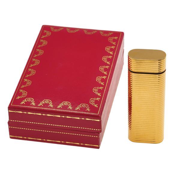 Gilded plated lighter. Signed and numbered Cartier, Paris n. 86792M. Fitted case. The lighter have not been tested and may need a service