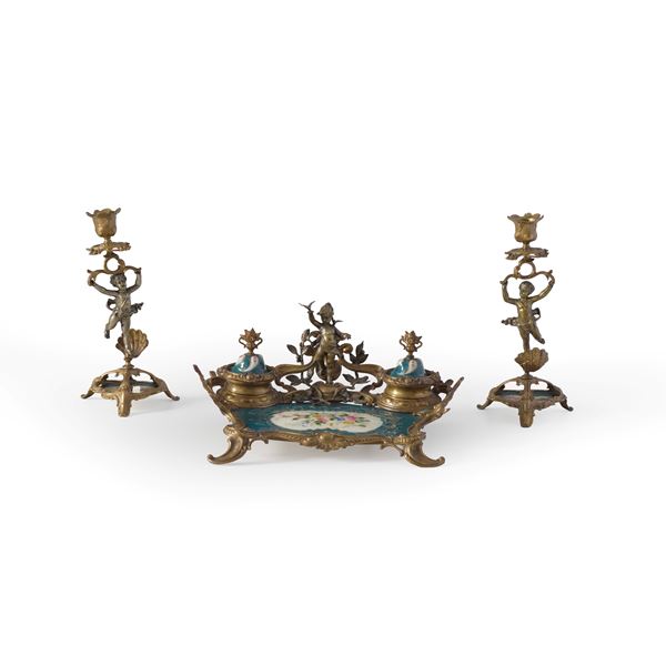 Calamaio e coppia di candelieri in metallo dorato e porcellana. Fine XIX-inizi XX secolo