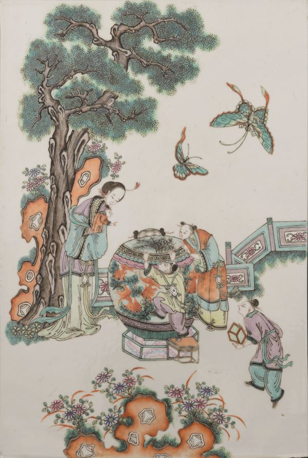 Famille rose porcelain plaque depicting a court scene with a young woman and children, China, Qing Dynasty, late 19th century.