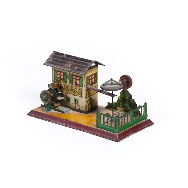 Giocattolo in latta dipinta a foggia di mulino a vento