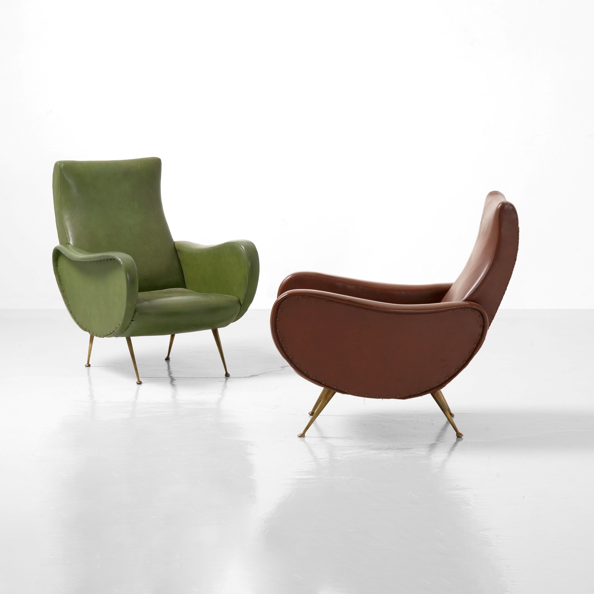 Produzione italiana, Due poltrone in stile art déco con rivestimento in skai e inserti in ottone,...