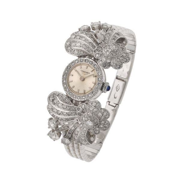Diamond and gold lady's wristwatch. Signed Longines. Minor damages. The movement has not been tested for the accuracy of time and may need a service