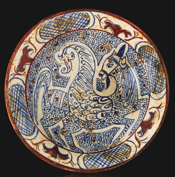 Terracotta dish depicting a mythological animal in blue and brown tones, Persia, 14th century.