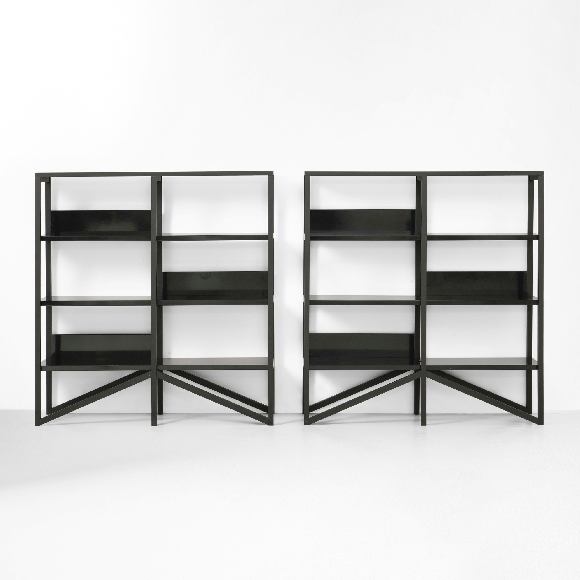 Due librerie, struttura in legno ebanizzato con mensole in metallo laccato (produzione ca. 2010)