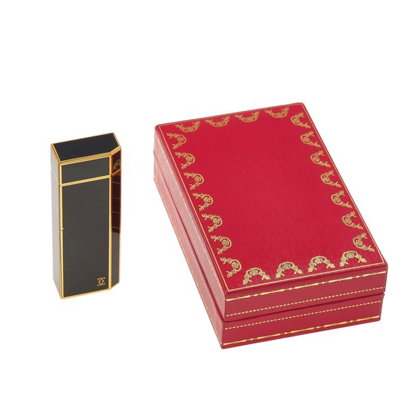Gold plaqued and enamel lighter. Signed and numbered Cartier n. 642892.  Fitted case.The lighter have not been tested and may need a service
