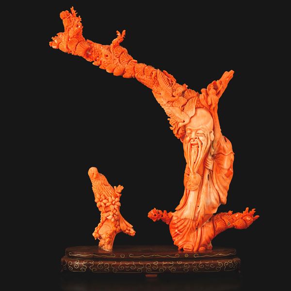 Carved coral figure of Shoulao and a bird, China, Qing Dynasty, 19th century.