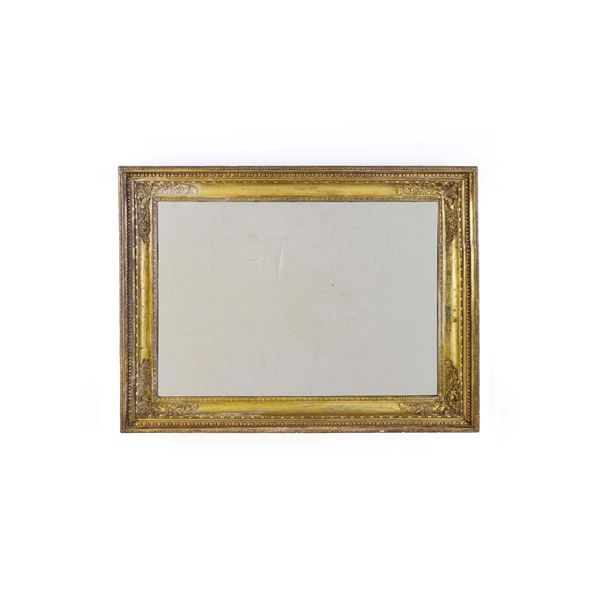 Grande cornice con specchio in legno intagliato e dorato, fregi in pastiglia. Francia, metà XIX secolo
