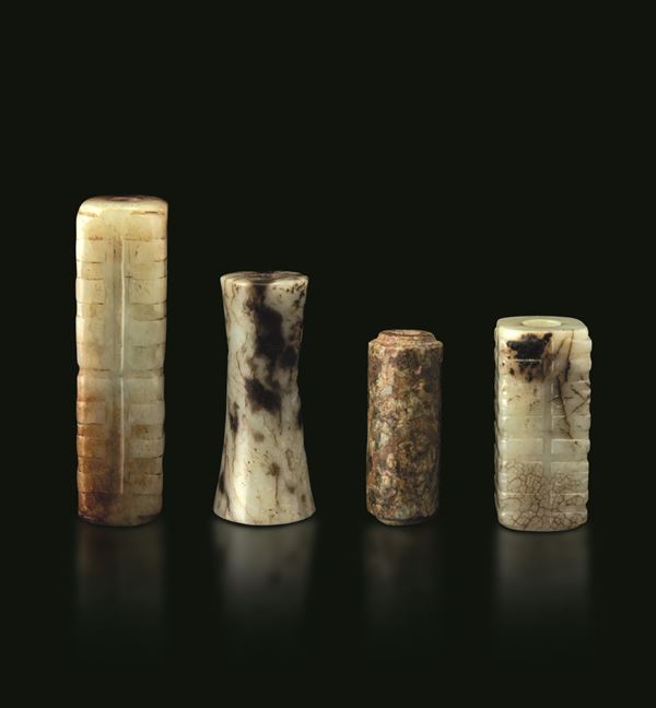 Lot comprising four jade mouthpieces, China, Qing Dynasty, 19th century.