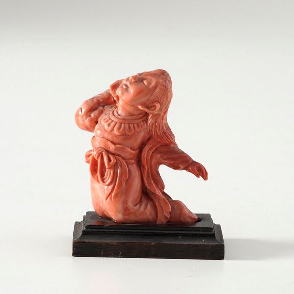 Coral figure of a kneeling young man
