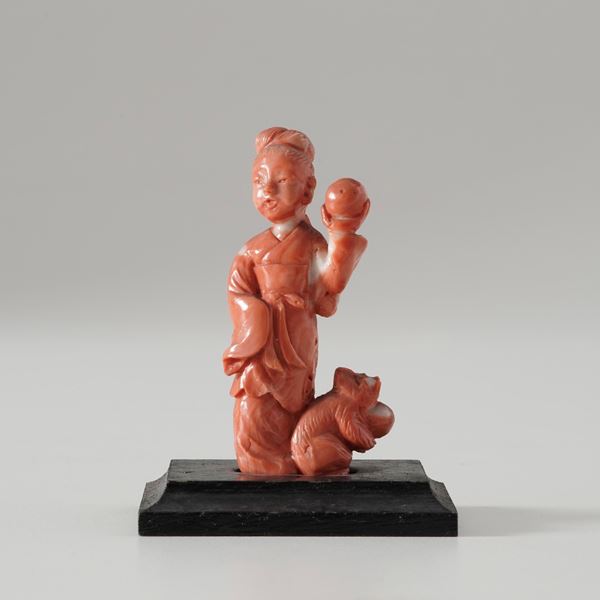 Coral figure of a lady with a squirrel