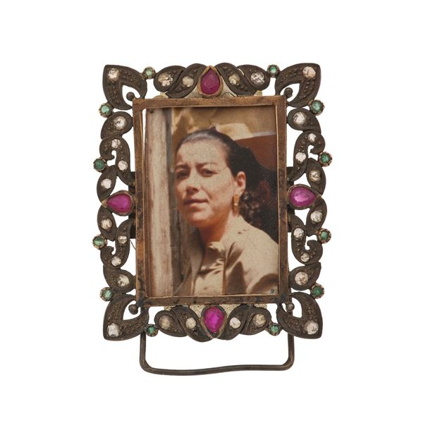 Small silver frame set with gemstones. Damages