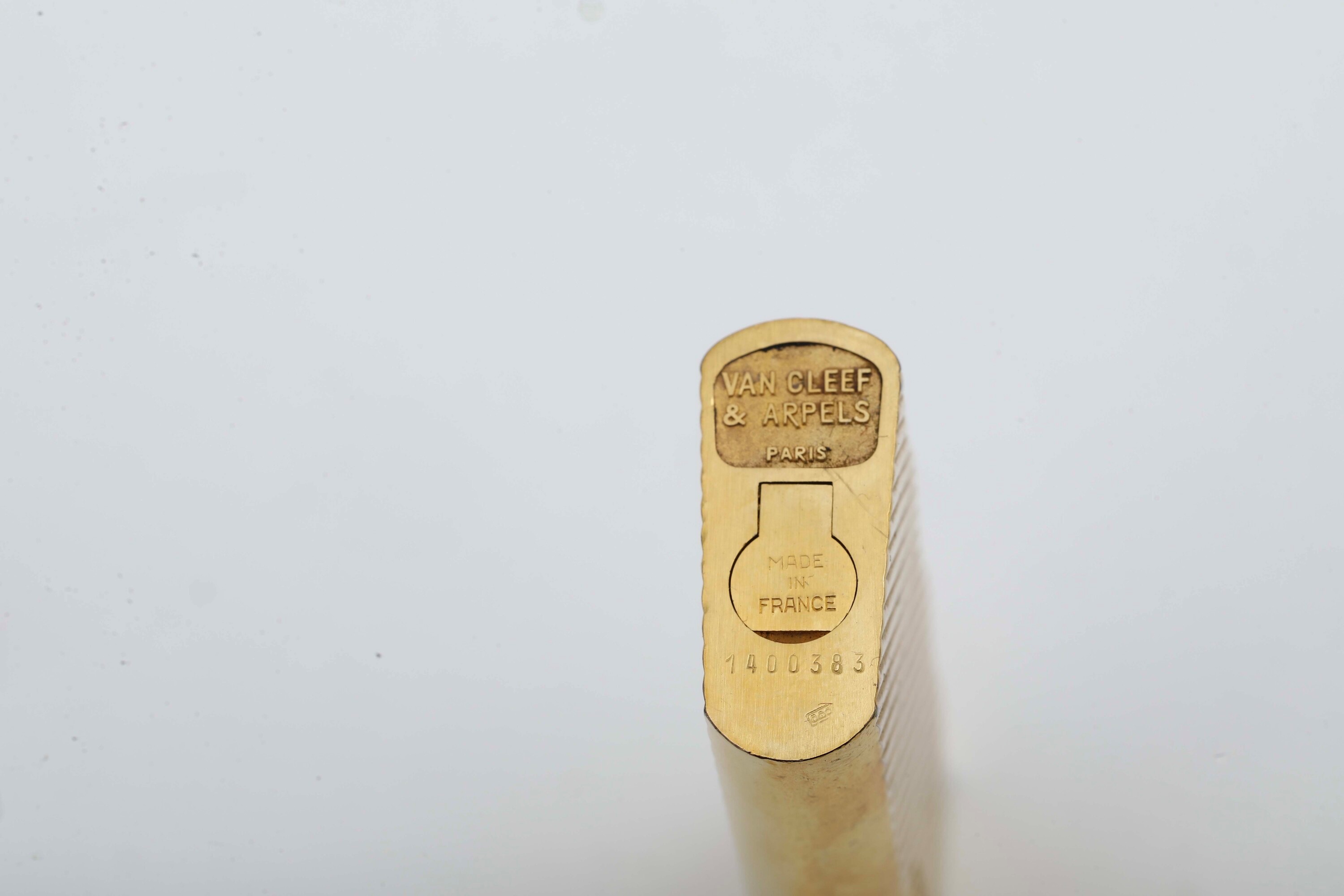 Van Cleef & Arpels, Coppia di accendini in metallo dorato con scatola originale e certificato di ...
