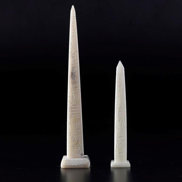2 obelisks carved from white marble