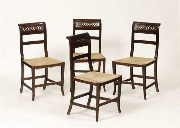 Quattro sedie con schienale traforato a motivi concentrici e sedile impagliato, XIX secolo