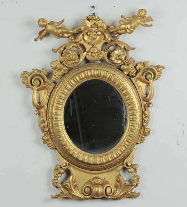 Specchierina ovale in legno intagliato e dorato, XIX secolo