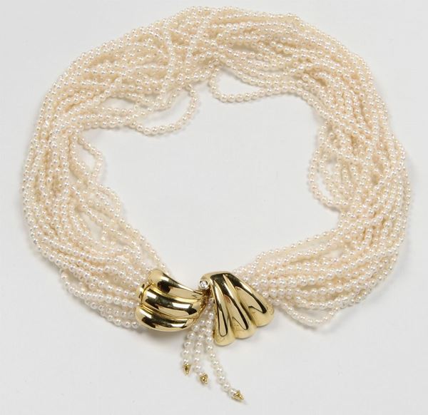 A multi strand pearl necklace. A gold clasp