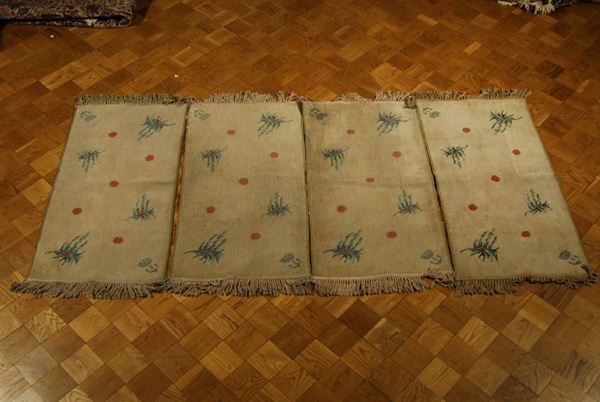 Lotto di quattro tappeti meccanici, XX secolo