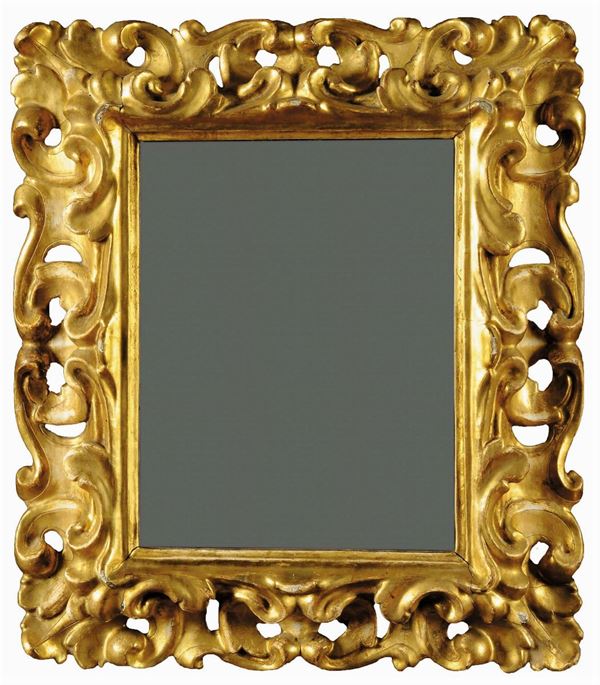 Specchiera in legno intagliato a volute e dorato, Toscana XVII secolo